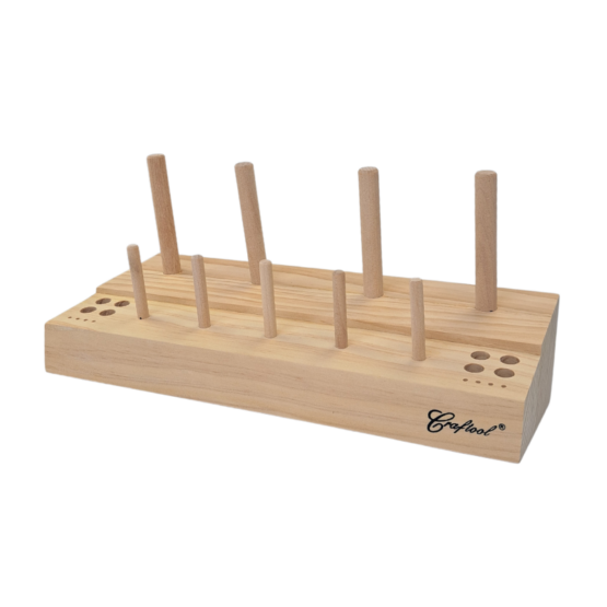 Wooden Thread Spool Rack. Holds 4 large thread spools, 5 small thread spools, and 8 needles. Also includes 4 holes for holding stitching awls and other small sewing tools.